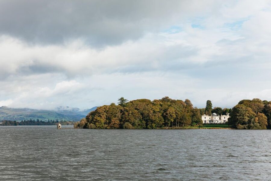 From Manchester: Lake District Bus Tour & Windermere Cruise - Coniston Water brings the bigger mountain views