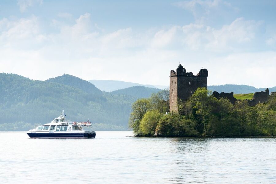 Loch Ness: Urquhart Castle Round-Trip Cruise - Boarding a modern boat with indoor and outdoor views
